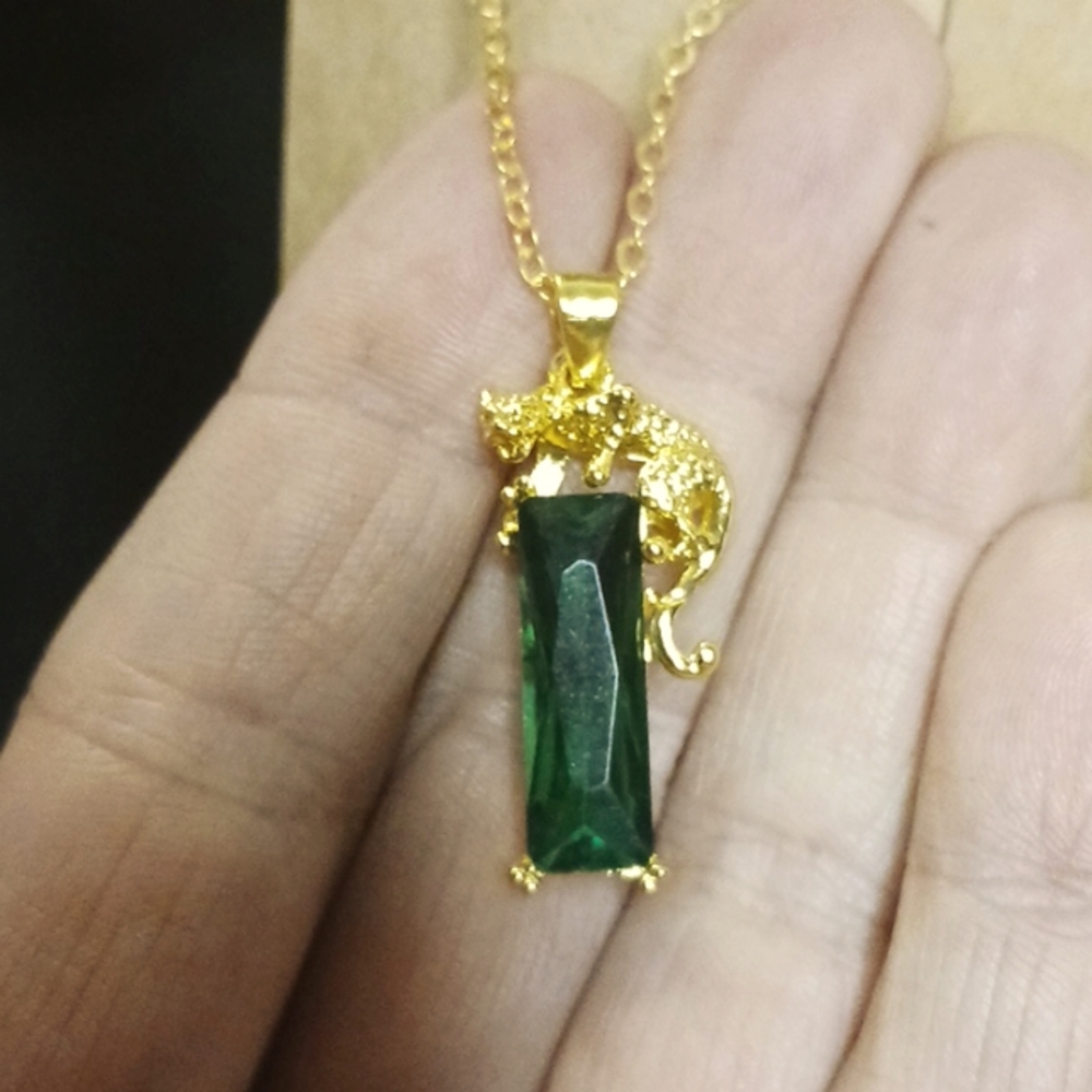 Gold Tigar Pendent with a large Emerald Stone on Gold necklace.